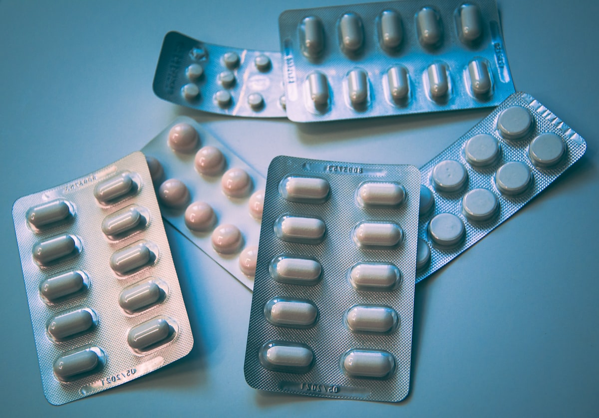 Organised medication bottles and pill organiser on a clean surface